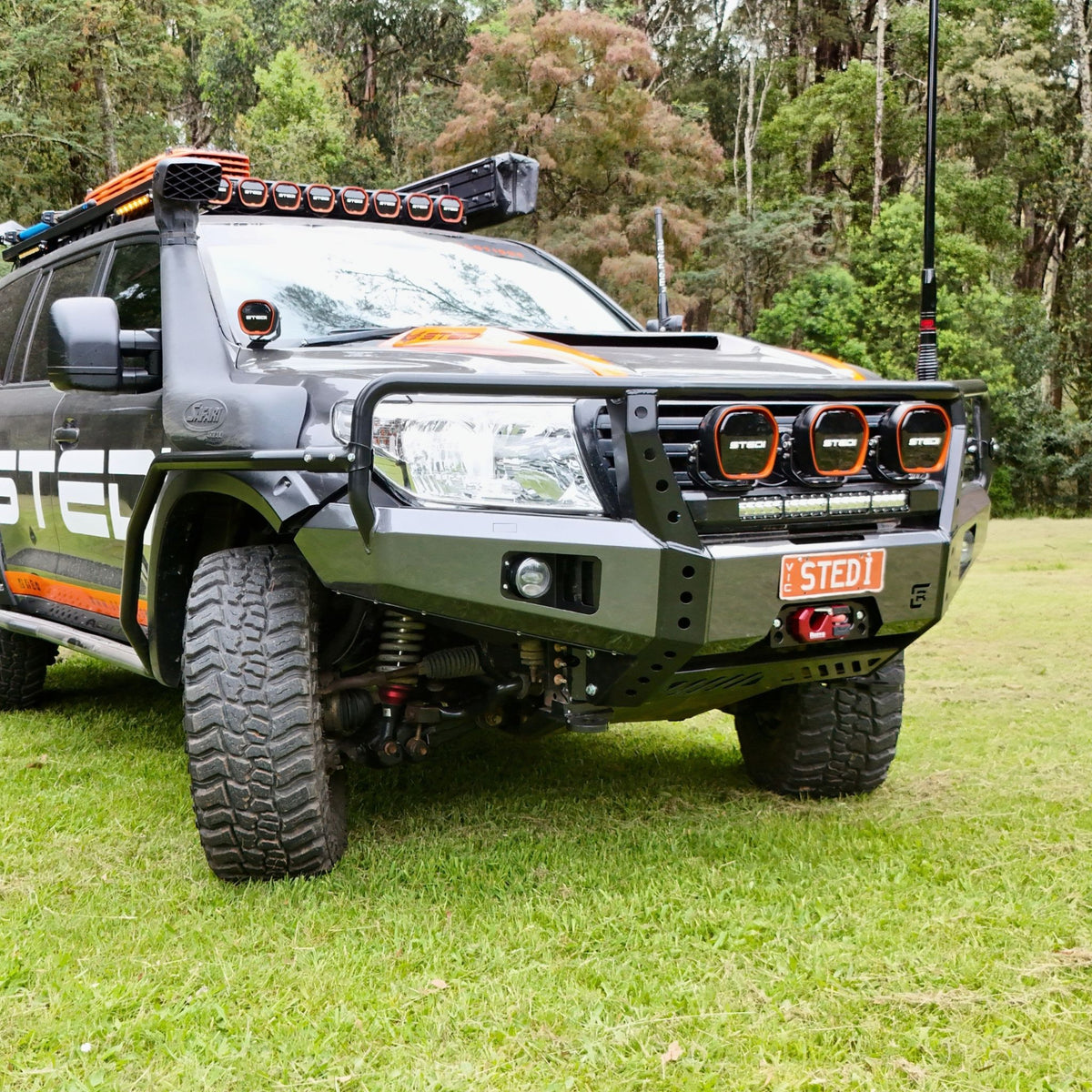 Raslarr Dallas Bull Bar Gunmetal Grey with Black on Toyota Landcruiser 200 Series branded with Stedi lights above view