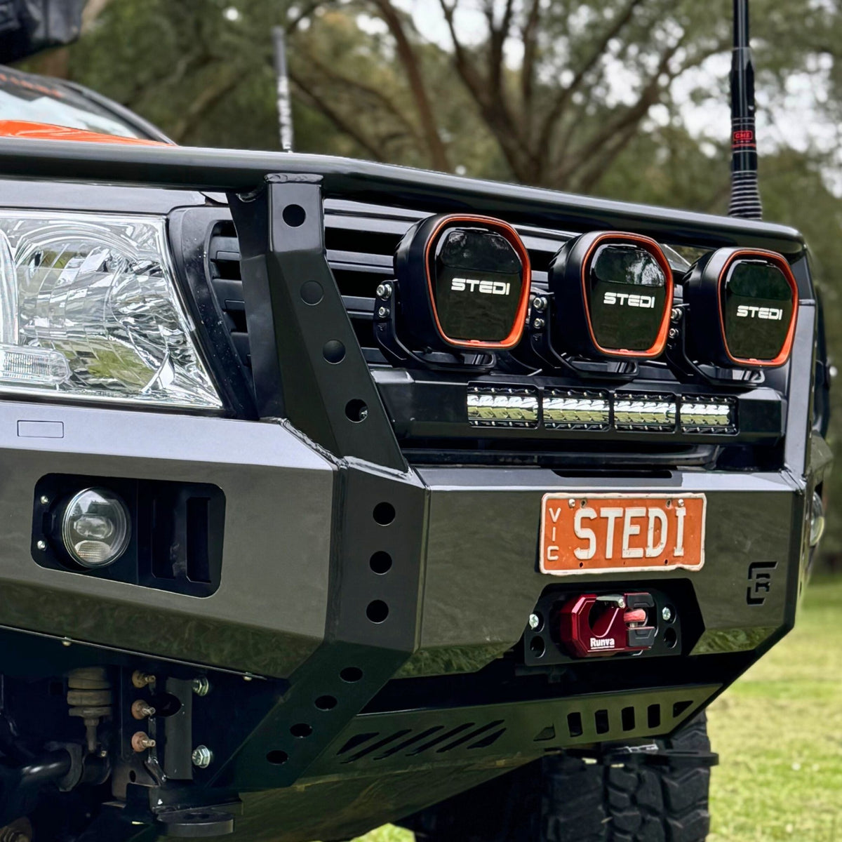 Raslarr Dallas Bull Bar Gunmetal Grey with Black on Toyota Landcruiser 200 Series branded with Stedi lights front view