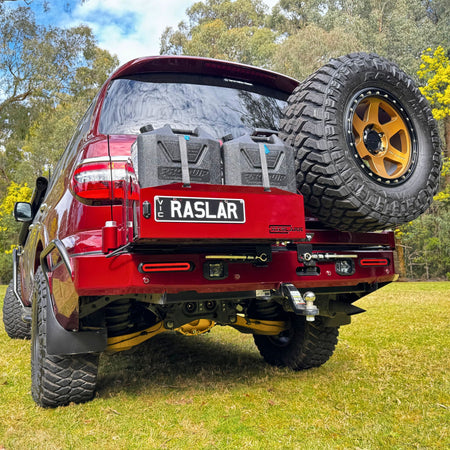 THis is an image of a Desert Red Nissan patrol Y62 with Rear Bar Wheel Carrier and Jerry Can holders