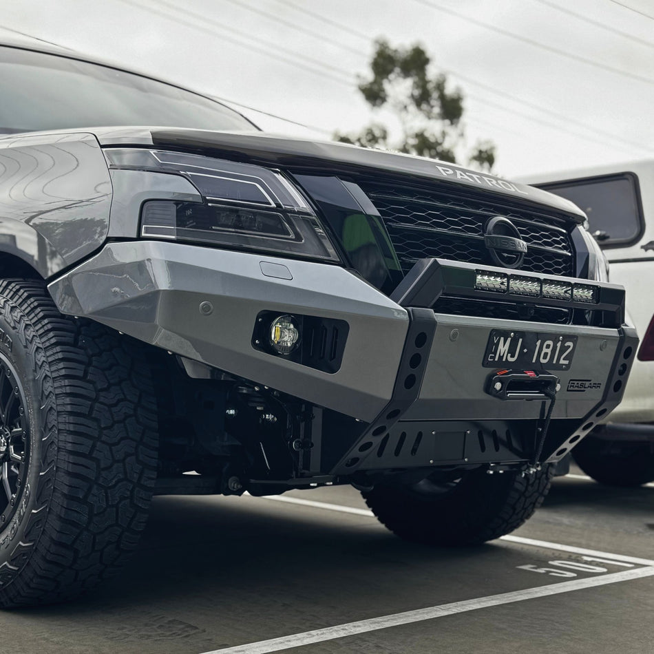 This is a photo of a Nissan patrol Y62 Winter low line Summit Stealth bull bar made by Raslarr Engineering in Lilydale, Melbourne VIC Australia Charcoal Black with light bar and winch 6