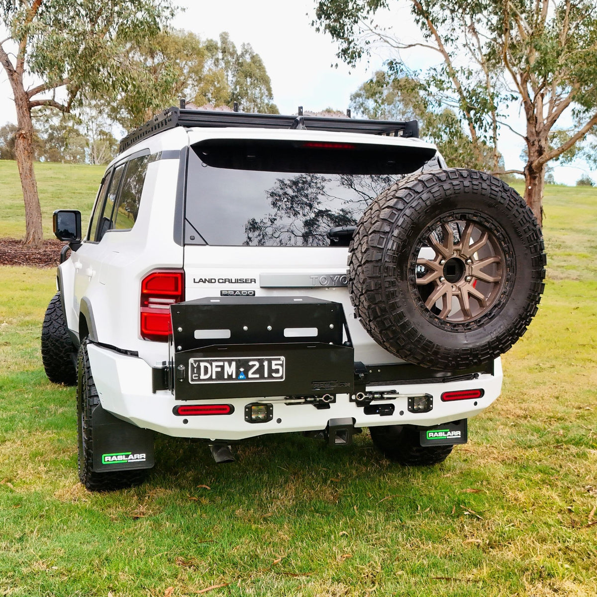 This is an image of the 250 Series Prado Toyota Landcruiser Rear Bar and Wheel Carrier setup by Raslarr Engineering Made in Australia White Black HERO photo