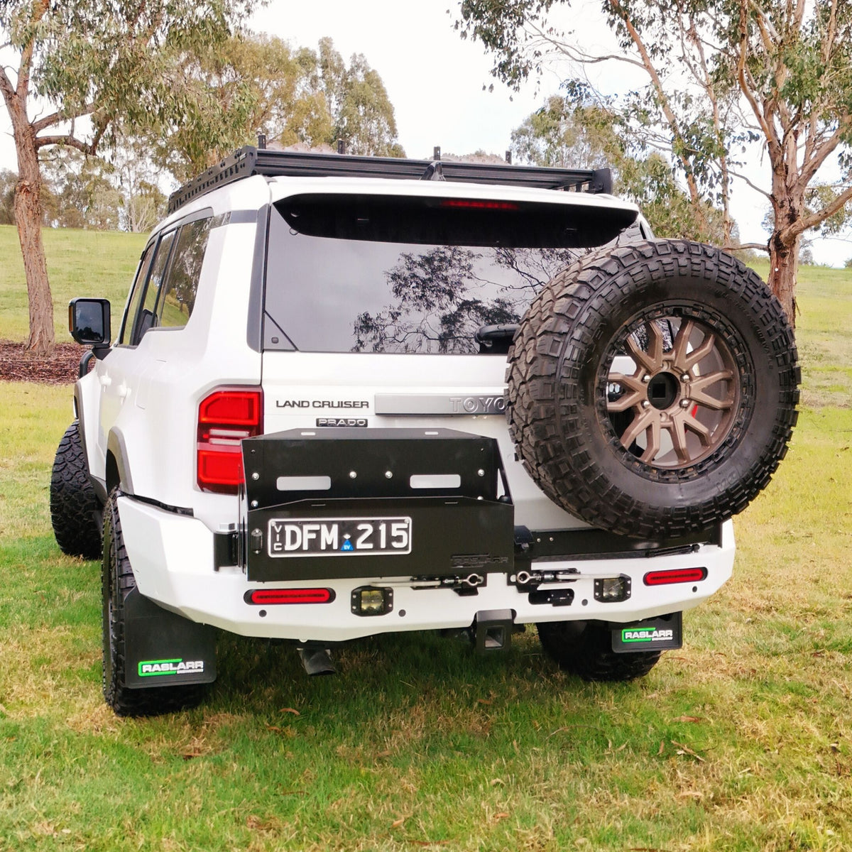 This is an image of the 250 Series Prado Toyota Landcruiser Rear Bar and Wheel Carrier setup by Raslarr Engineering Made in Australia White