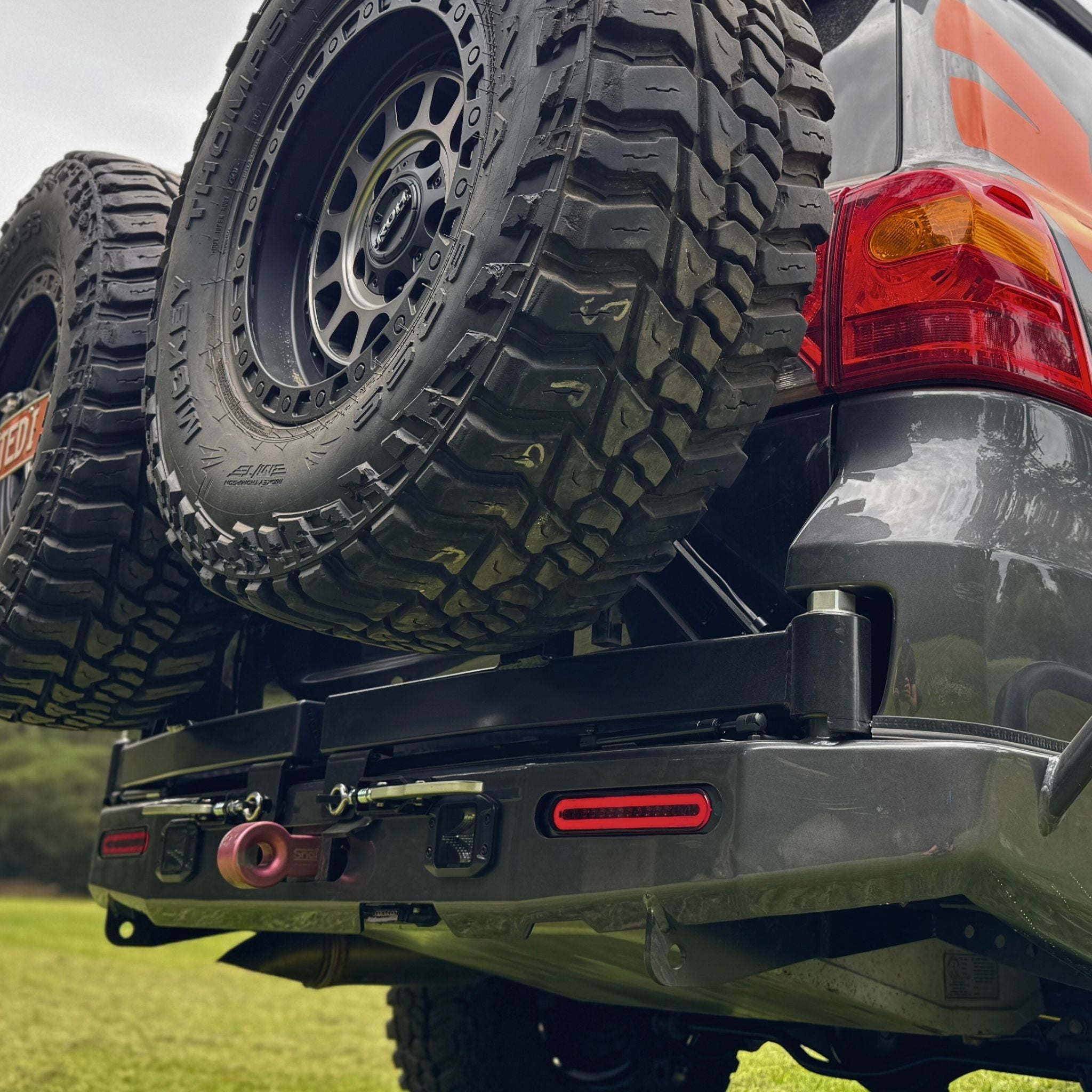 This is an image of the Raslarr V2 Rear Bar with Dual Wheel Carriers on the Stedi LED Lights 200 Series Toyota Landcruiser in Lilydale, Melbourne, Cape York, side hoops